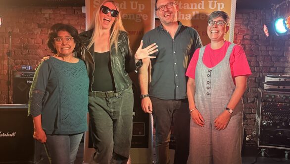 2025's Stand Up Challenge participants stand on stage together
